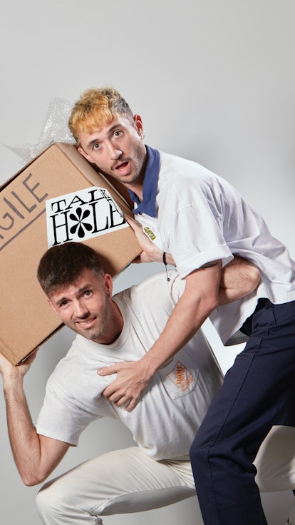 Eric Schwarau and Steven Phillips-Horst carrying a box marked fragile.