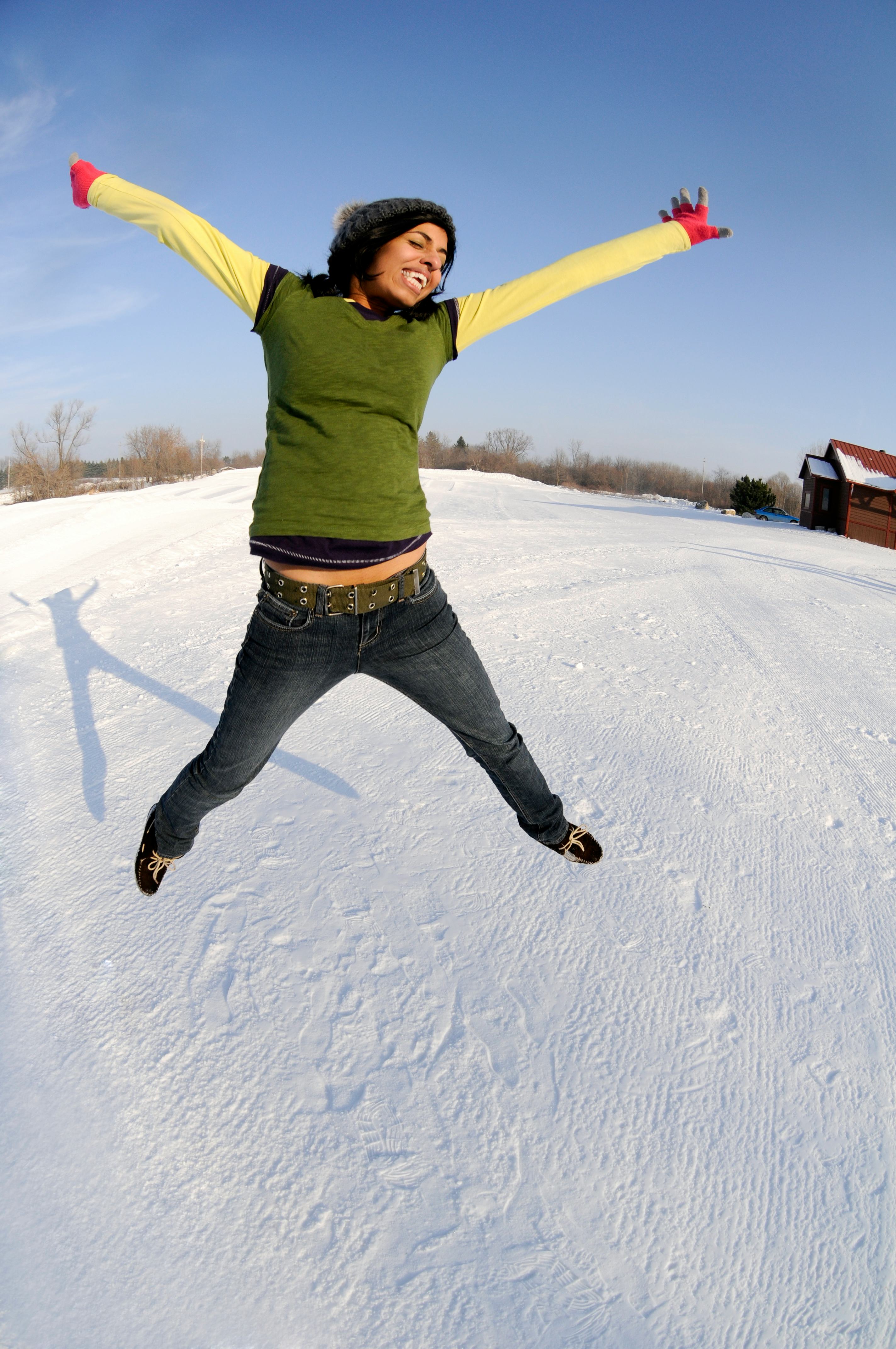 Young woman jumping for joy on Feb. 3, 2022, the best day of the month for every zodiac sign.
