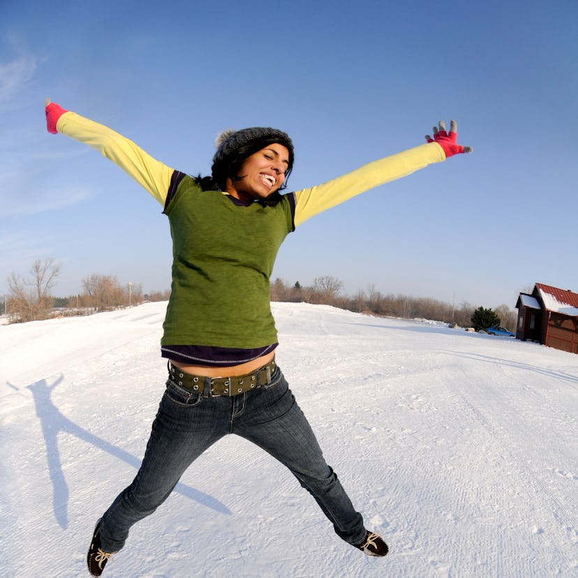 Young woman jumping for joy on Feb. 3, 2022, the best day of the month for every zodiac sign.