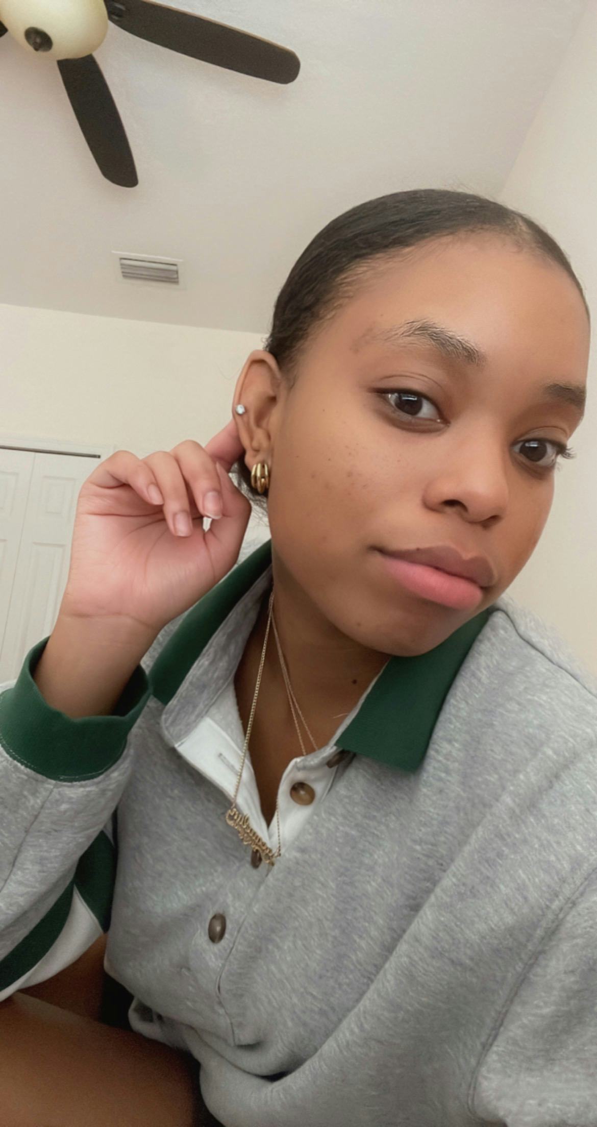 A young woman with injected lips taking a selfie