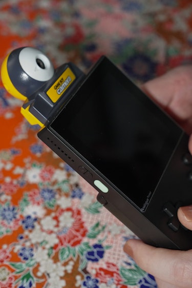 A photo of the Analogue Pocket with a Game Boy Camera inserted