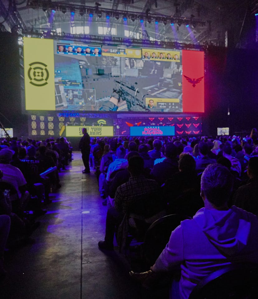 Photo from a Call of Duty League live event showing lots of people sitting close together in audienc...