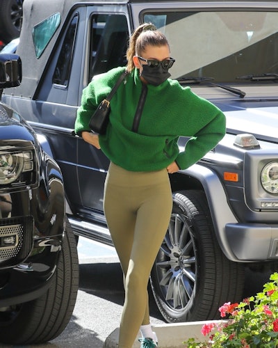 Hailey Bieber wears green Aritzia Tna fleece sweatshirt.