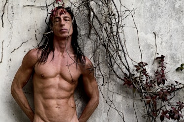 A naked Rick Owens showing off his abs