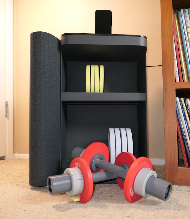 The Tempo Move with a phone mounted on top and dumbbells sitting in front.