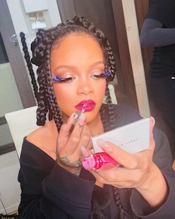 Rihanna applying Fenty Beauty lipstick