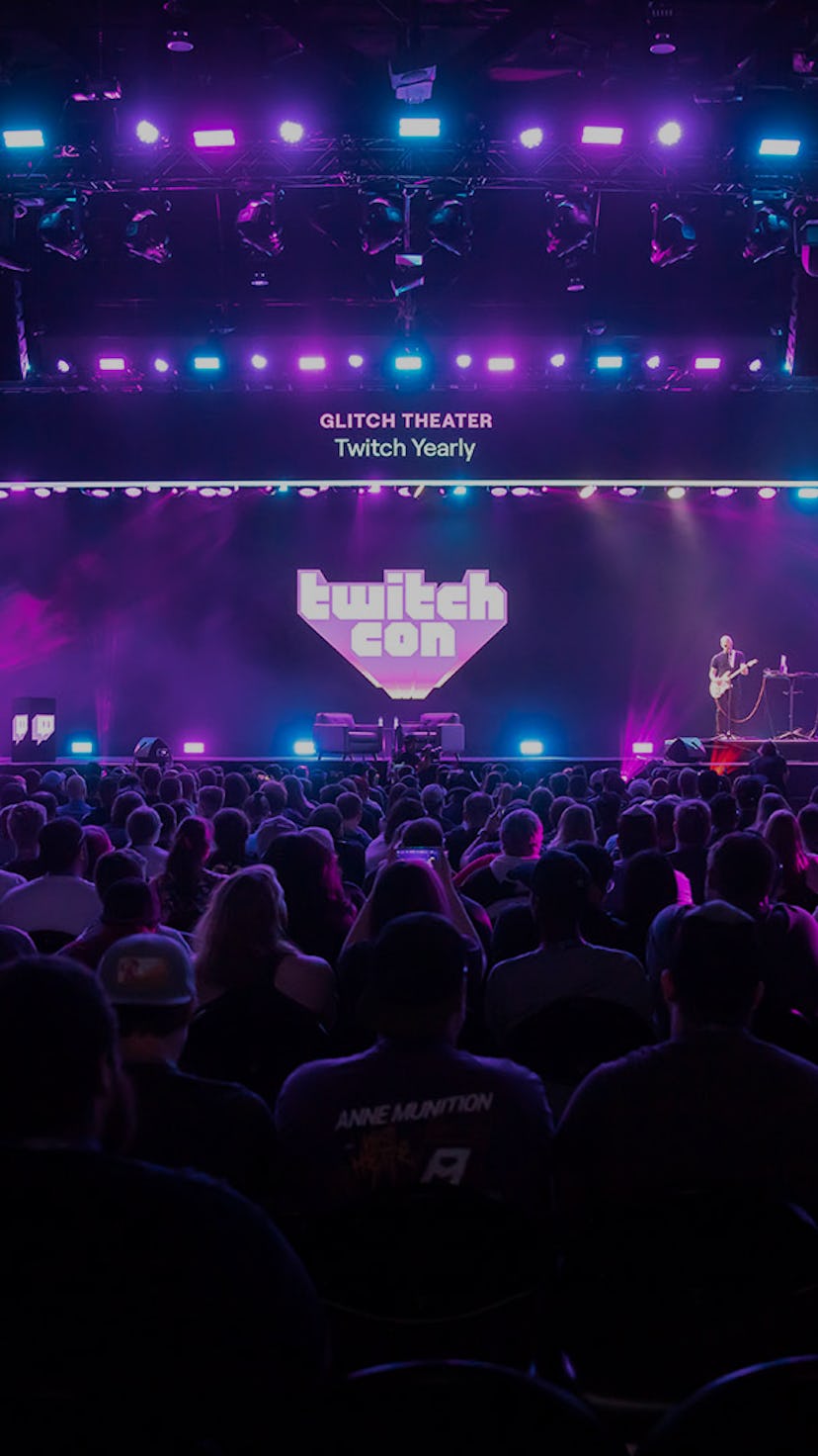 Photo from a past Twitch con showing purple screen with Twitch Con logo and crowd of people seated f...
