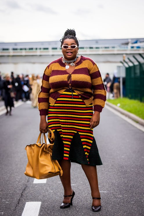 Gabriella Karefa-Johnson wears a burgundy and yellow stripe cardigan and skirt
