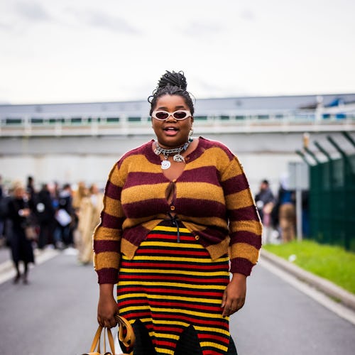 Gabriella Karefa-Johnson wears a burgundy and yellow stripe cardigan and skirt