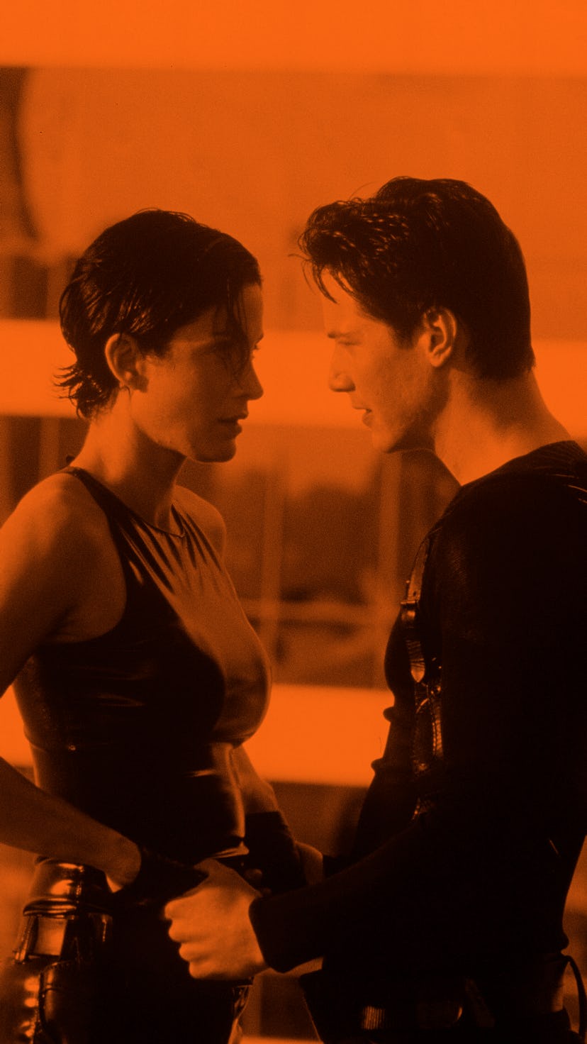 Carrie-Anne Moss in all-black latex and Keanu Reeves in all-black in "The Matrix"