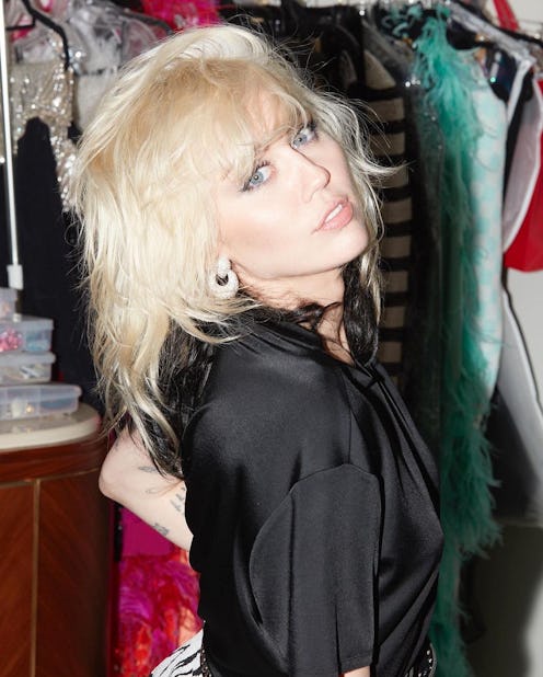 Miley Cyrus with Silver eyeshadow that signals a possible disco glam revival and a black dress