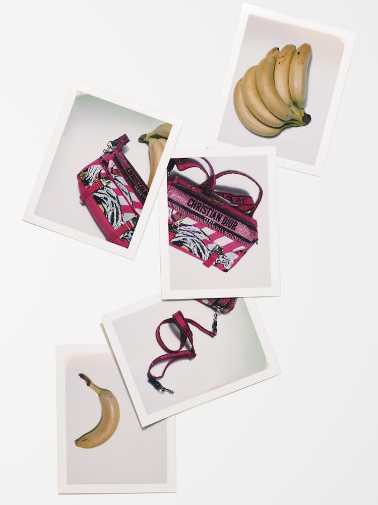 A pink Dior bag among bananas.