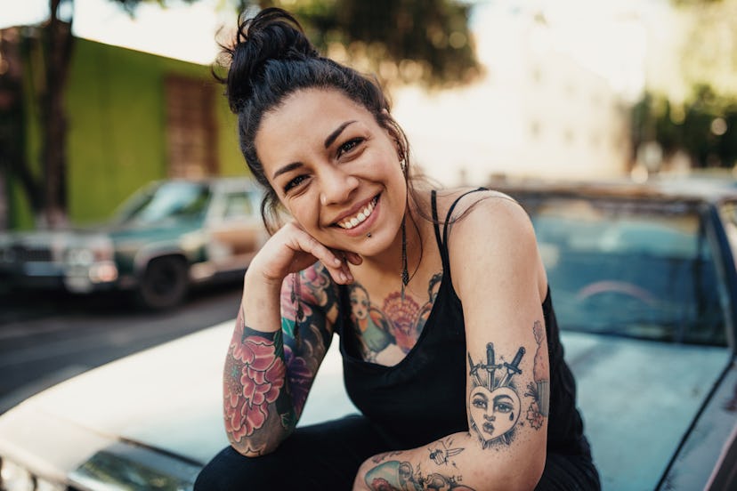 woman with tattoos smiling