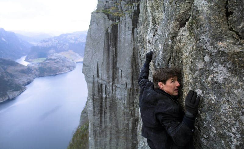 Tom Cruise climbing a cliff