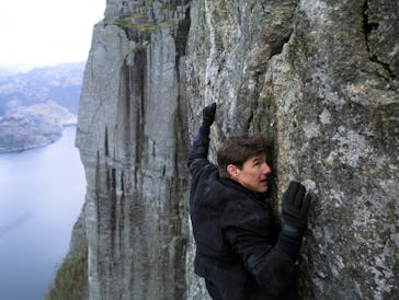 Tom Cruise climbing a cliff