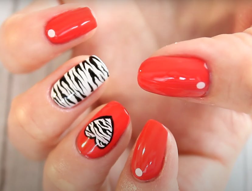 Close up of Valentine's Day nail design; red polish with zebra print