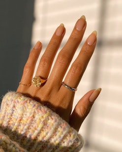 A close-up of a sun-kissed hand with the 'boring' nail trend that is poised to become the It Girl Ma...