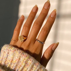 A close-up of a sun-kissed hand with the 'boring' nail trend that is poised to become the It Girl Ma...