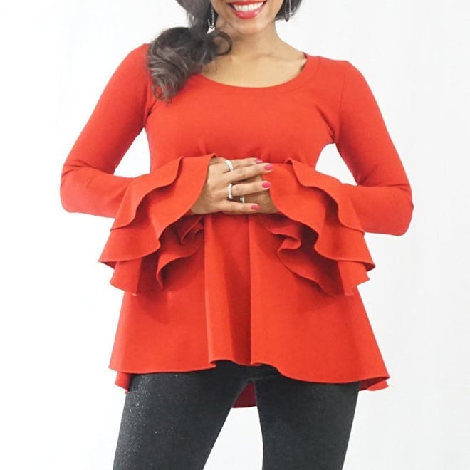 Pregnant woman modeling red shirt with flare sleeves