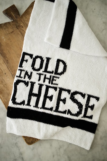 This "fold in the cheese" towel was made with a knit kit from the 'Schitt's Creek' knitting collecti...