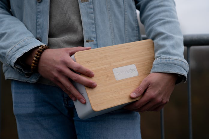 A view of the Steambox held in a person's hands