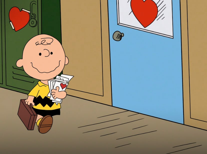 Charlie Brown walks down a school hallway decorated with hearts, clutching valentines.