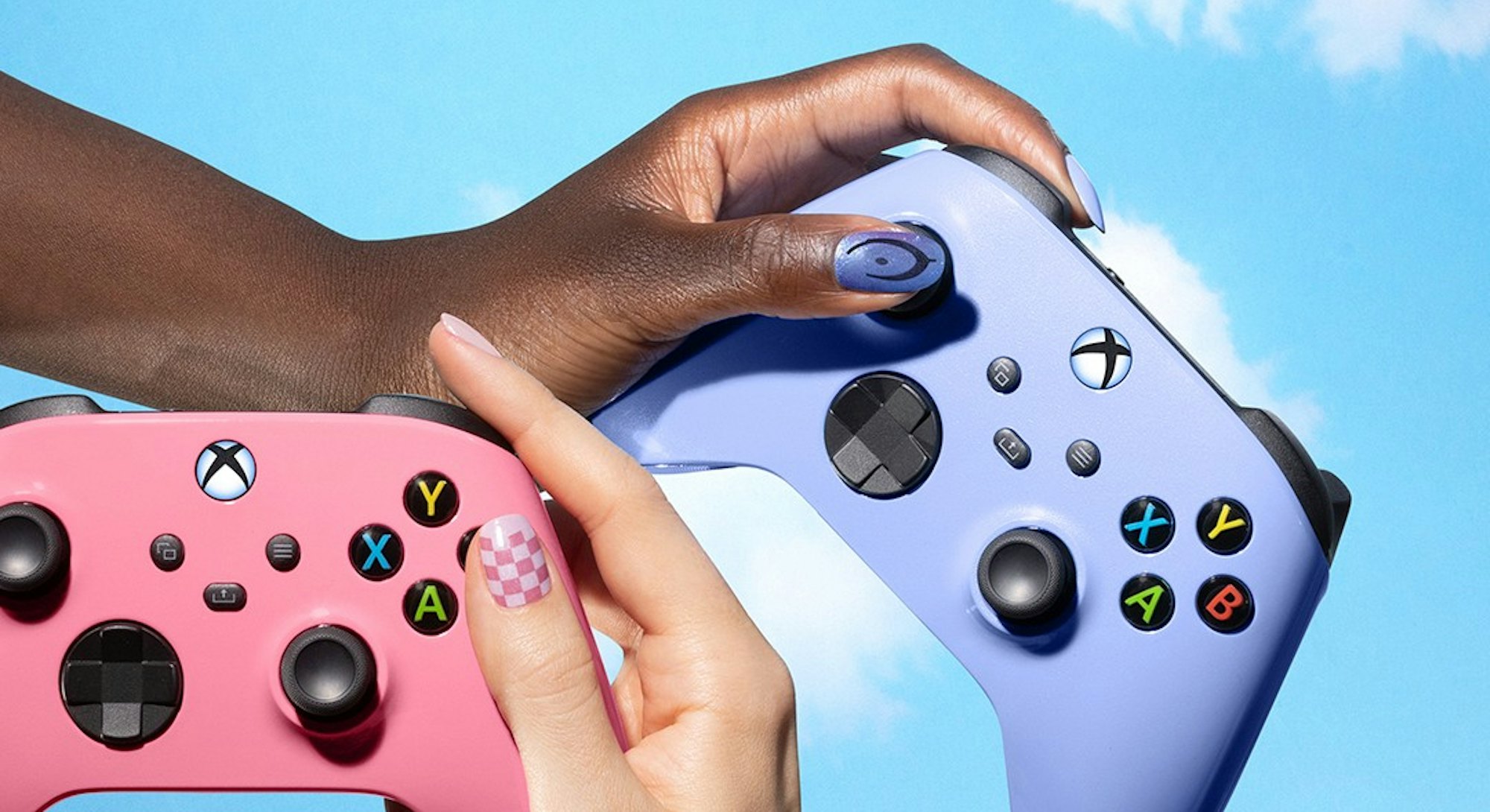 hands with nail polish holding Xbox controllers