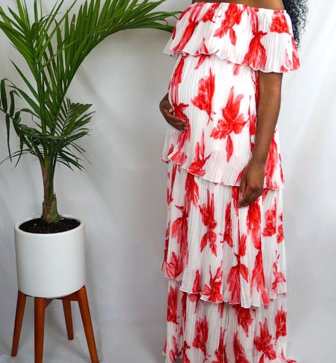 Pregnant woman modeling red and white maxi dress