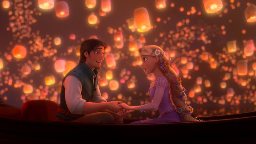 Flynn Rider and Rapunzel hold hands in a canoe, surrounded by floating lanterns.