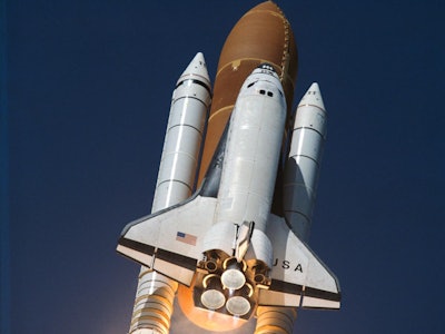 The space shuttle with its three main engines shooting off into space