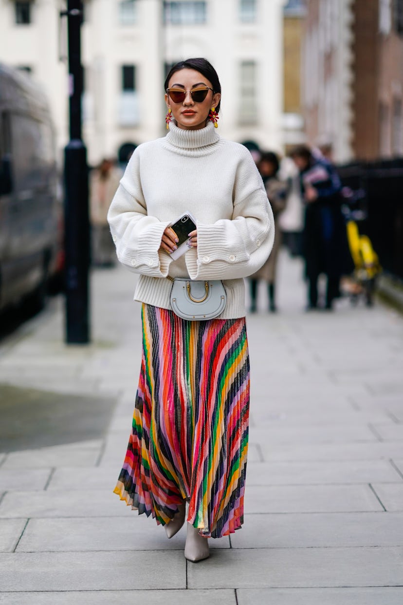 A guest wears a cozy sweater with a rainbow skirt.