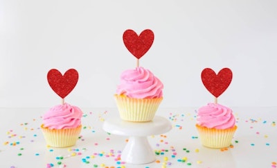 Three cupcakes with heart toppers