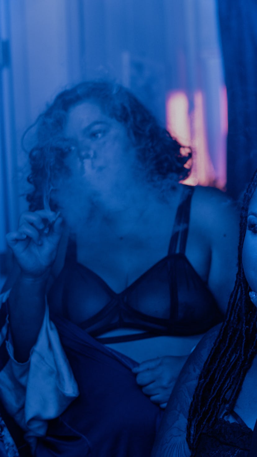 A group of girls smoking marihuana, wearing lingerie.