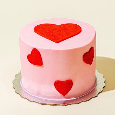 Cake with pink icing and heart details