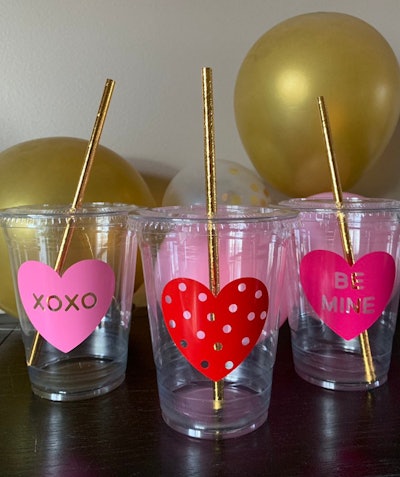 Plastic cups with hearts; with gold straws