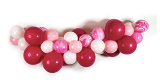 Balloon garland with red, pink, and white balloons