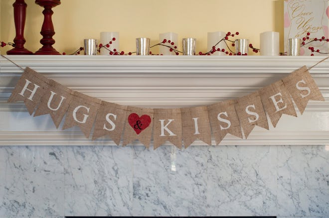 Burlap banner that says "hugs & kisses" hanging on mantle 