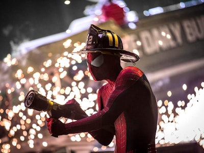 Andrew Garfield wearing a firefighter hat as Spiderman 