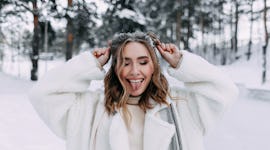 Young woman sticking her tongue out because she's one of the four zodiac signs least affected by the...