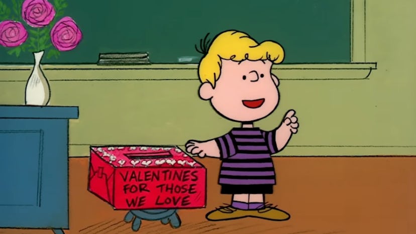 Schroder stands next to a Valentine's Day mailbox in the front of the classroom.
