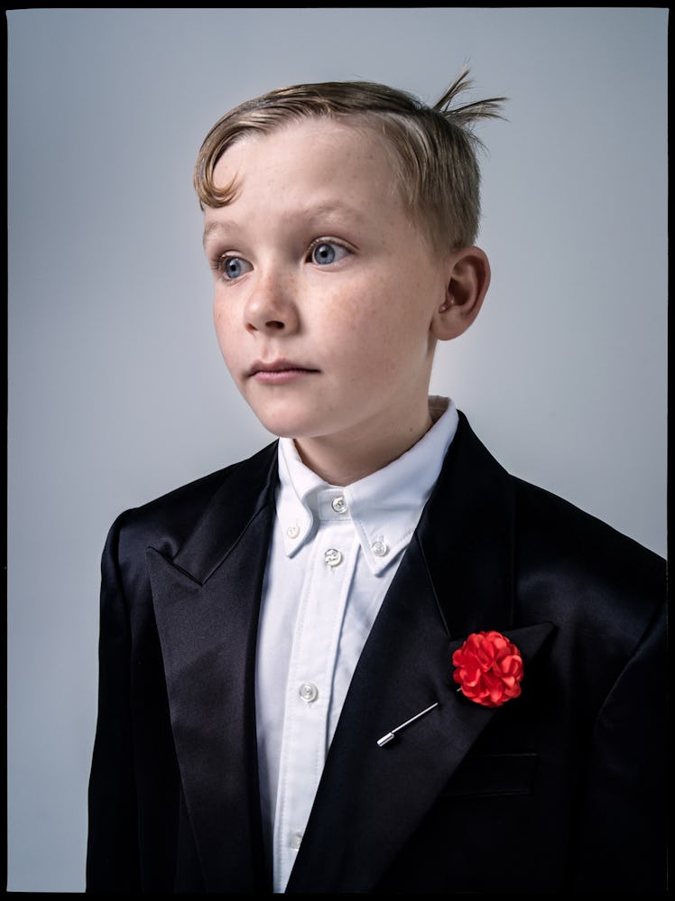 Jude Hill wears a Saint Laurent by Anthony Vaccarello coat; Raf Simons shorts; Thom Browne shirt; F...
