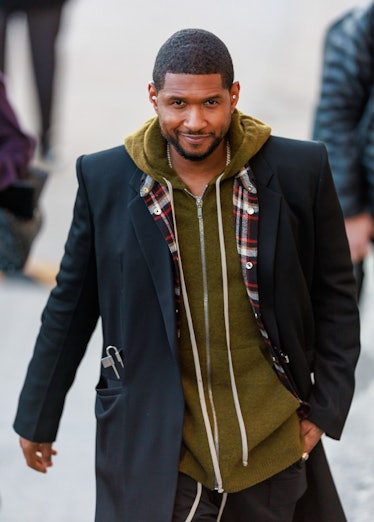 Usher wearing a green hoodie