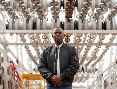 the artist charles gaines stands in front of his artwork moving chains