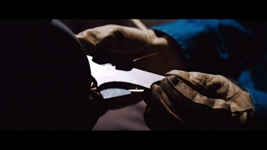 Bruce Wayne sharpening his gadgets.