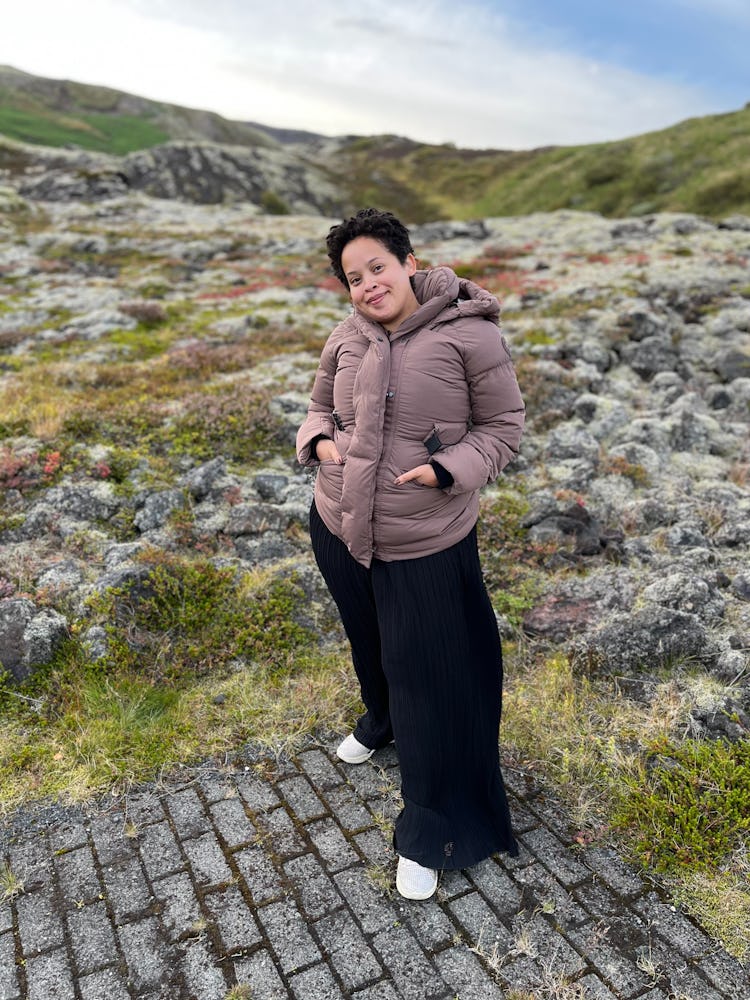 Natasha Marsh wearing a canada goose marlow coat while standing next to a rocky field