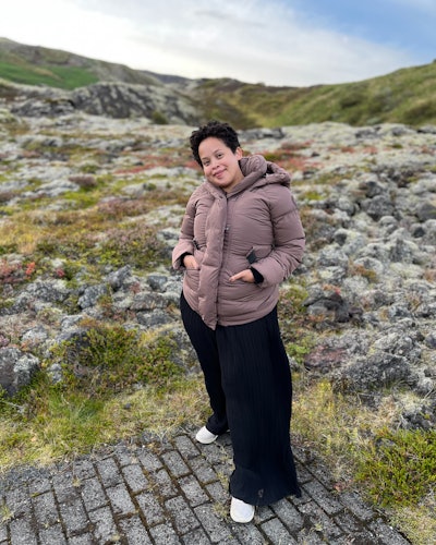 Natasha Marsh wearing a canada goose marlow coat while standing next to a rocky field