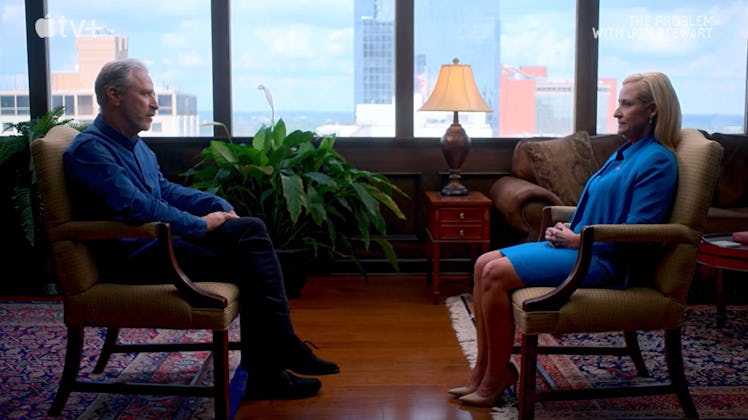 Jon Stewart in a chair opposite Leslie Rutledge.