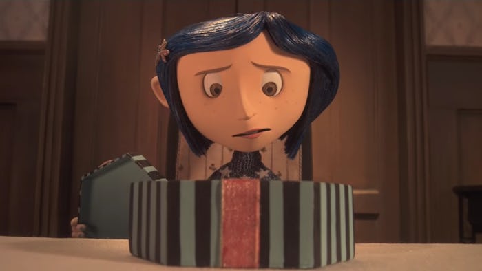 Coraline looks fretfully into a box.