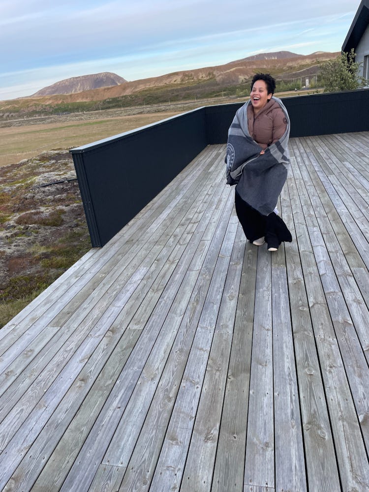 Natasha Marsh wearing a canada goose marlow coat while standing on a wooden deck