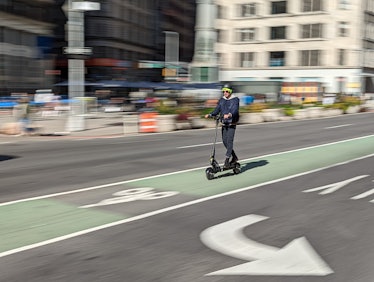 Man riding e-scooter.